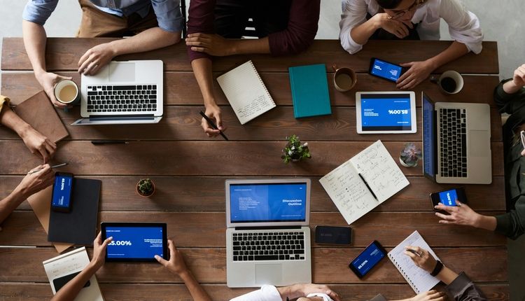 Coworkers gathered around a table during a meeting